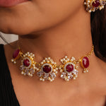 Load image into Gallery viewer, Close-up of a person wearing gold jewelry with red stones
