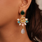 Load image into Gallery viewer, Close-up of an ear wearing a colorful gemstone earring with a blurred background
