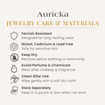 Load image into Gallery viewer, Auricka jewelry care and materials information on a white background
