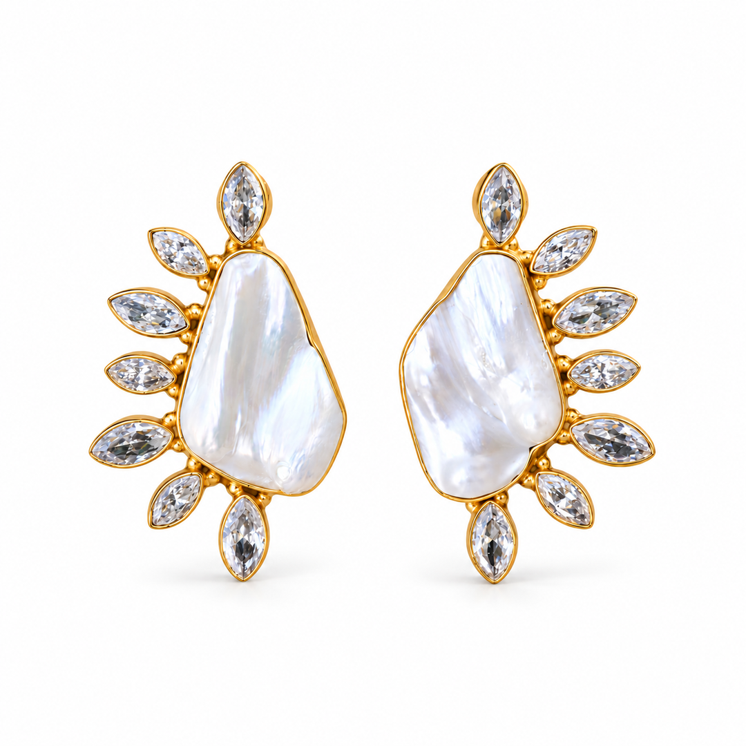 Pair of baroque pearl and cubic zirconia leaf-frame stud earrings in gold-tone settings on a white background