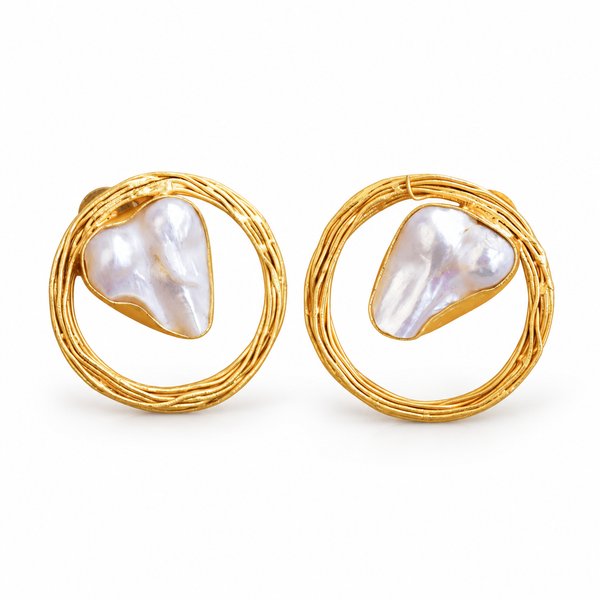 Baroque pearl stud earrings inside woven gold-tone circle frames on white