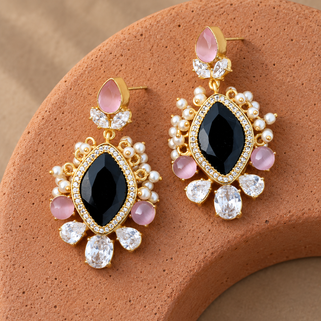 Black and pink crystal statement drop earrings on a terracotta arch