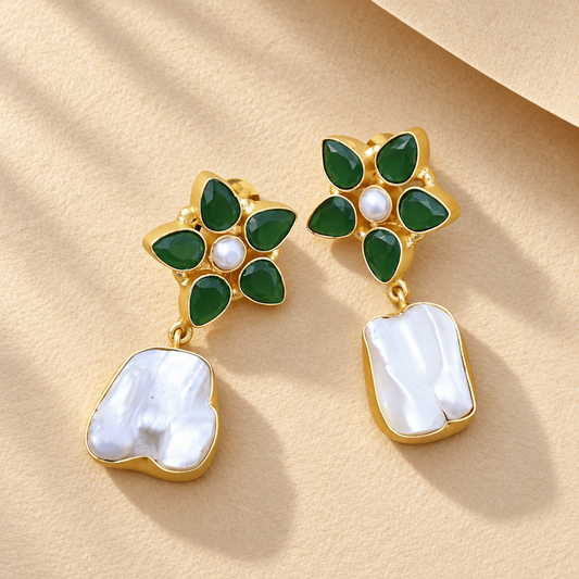 Green Floral Crystal & Baroque Pearl Drop Earrings on champagne paper