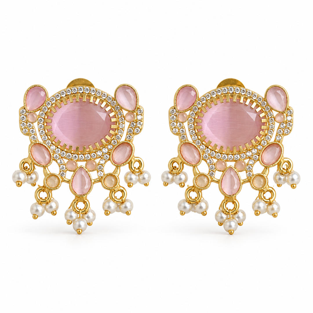 Pink crystal statement stud earrings with zirconia and white bead fringe on a white background